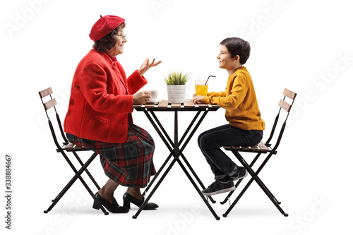 Grandmother and grandson sitting in a cafe and talking