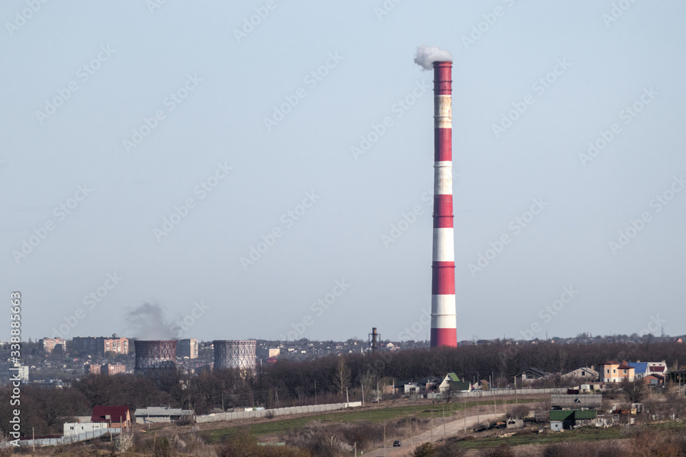 Energy heat power station pipe with red white stripes. Europe, Ukraine industrial clear sky landscape with air pollution smoke tower