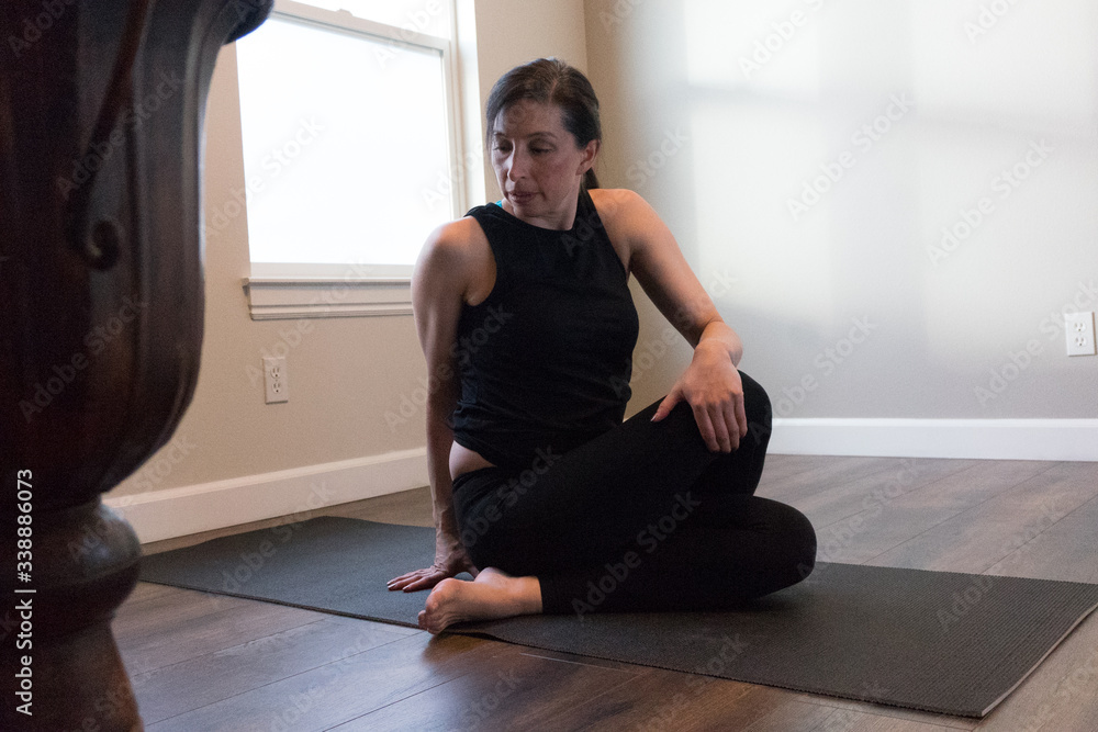 Fototapeta premium Women doing yoga indoors in home 