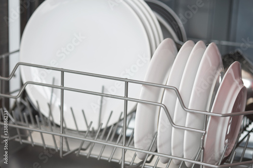 Dishwasher inside with clean dishes.