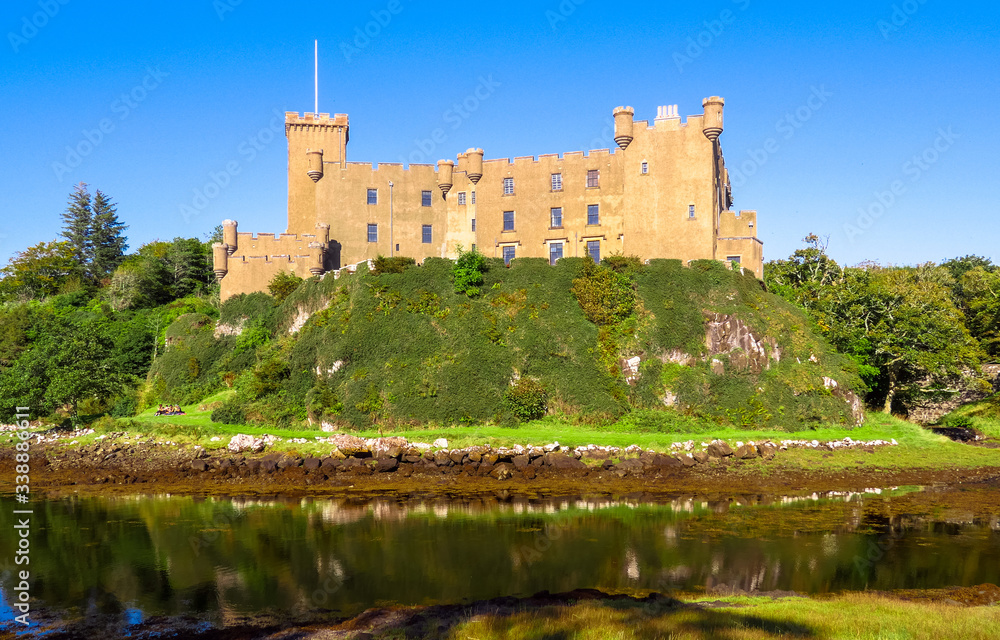 Dunvegan, Scotland / United Kingdom - August 25, 2014: The Dunvegan Castle on the shore of Loch Dunvegan Dunvegan, Scotland / United Kingdom - August 25, 2014: The Dunvegan Castle on the shore of Loch Dunvegan