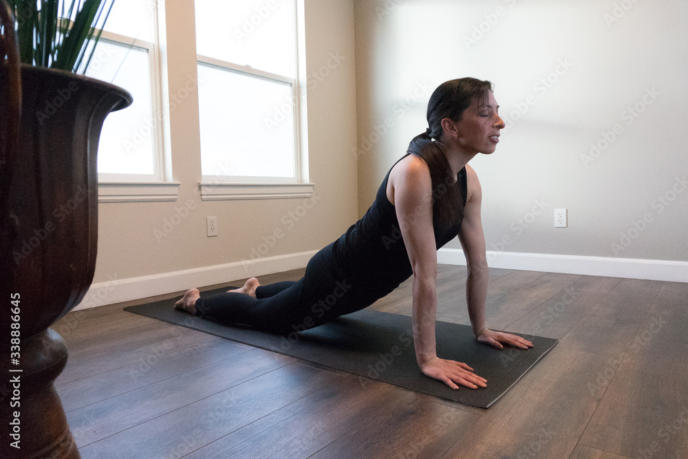 Women doing yoga indoors in home 