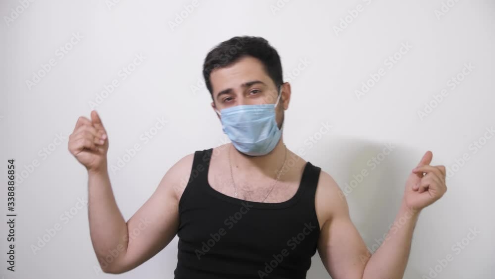 Caucasian man in a medical mask dancing fanny dance white background Covid19 Coronavirus Caucasian man in a medical mask dancing fanny dance white background Covid19 Coronavirus