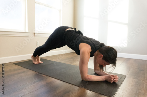 Women doing yoga indoors in home 