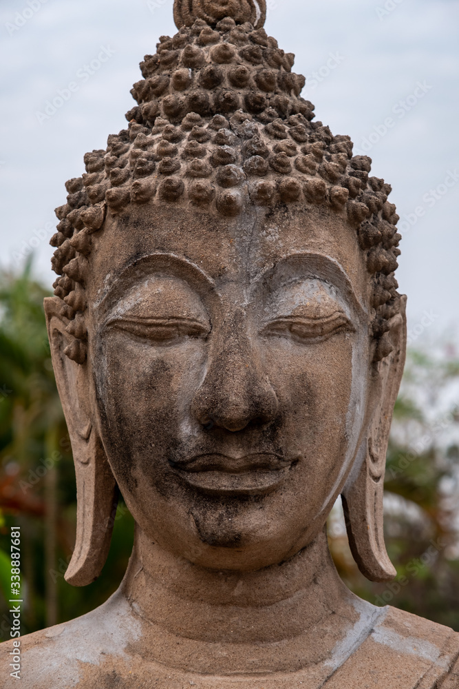Close up photo of Buddha face or head, ancient stone Buddha face 