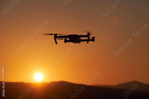 Drone flying at the sunset on red sky