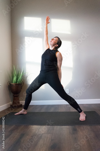 Women doing yoga indoors in home 