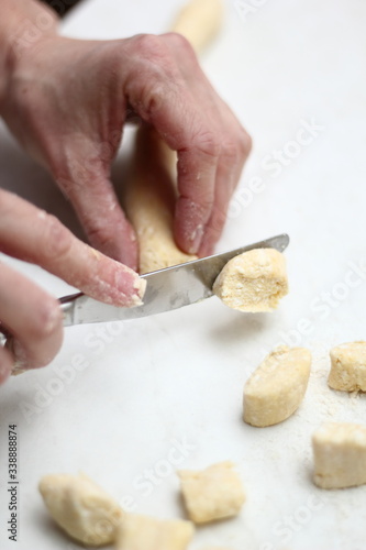 Gnocchi being prepared. Cutting dough. Dough dumplings with cheese.