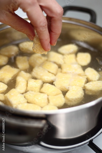 Gnocchi being prepared. Adding into boiled water. Dough dumplings with cheese.