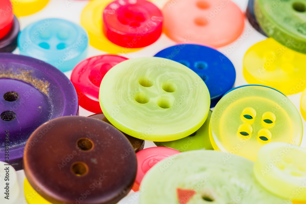 Buttons of various coloures spread around the surface. Buttons of various coloures spread around the surface.