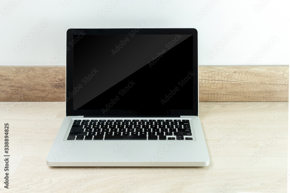 Laptop with black screen isolated on a wooden desk Laptop with black screen isolated on a wooden desk
