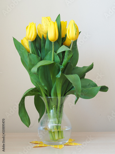 Bouquet of yellow tulips in a glass vase