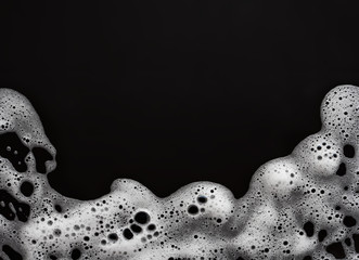 soap foam on black background, with copy space