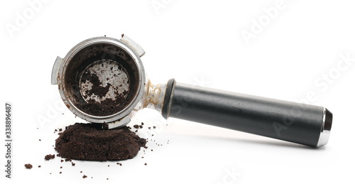 Milled coffee sediment, residue with espresso machine handle, scoop isolated on white background