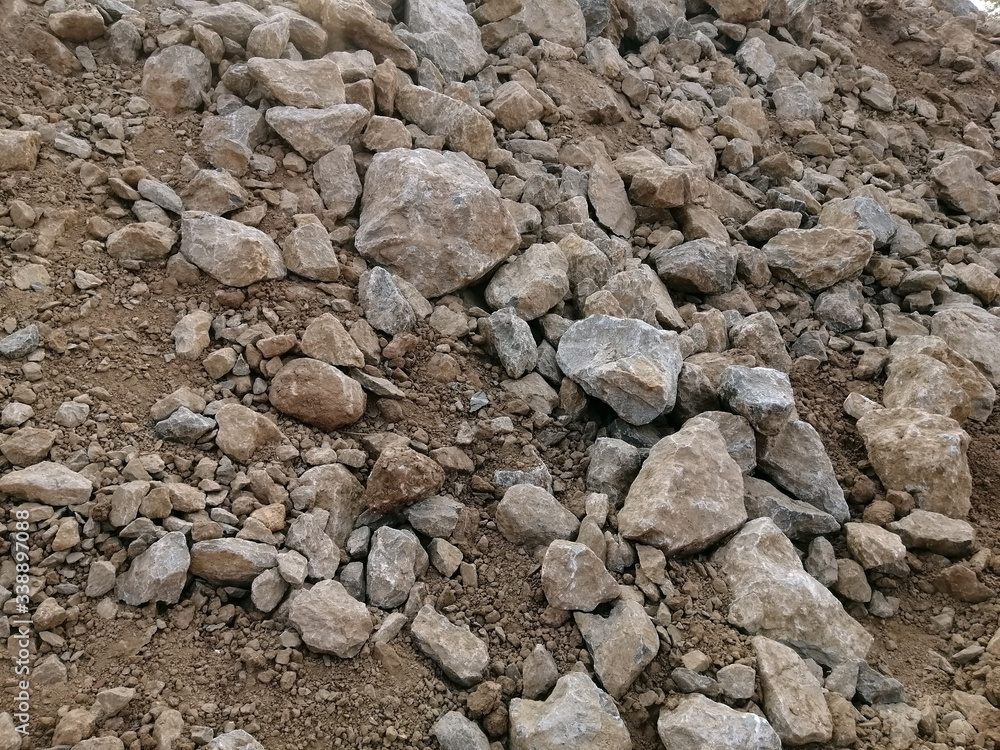 A pile of limestone on the construction site. Industrial background with pile of gravel. A pile of limestone on the construction site. Industrial background with pile of gravel.