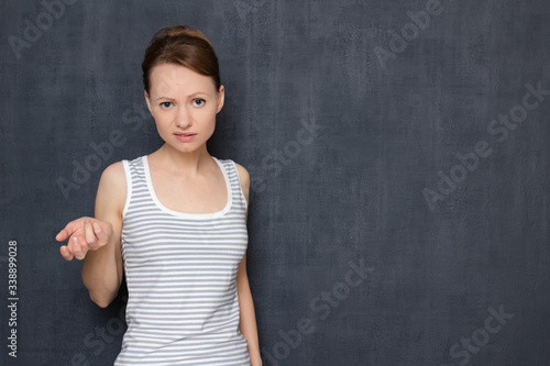 Portrait of dissatisfied indignant blond girl rebuking somebody