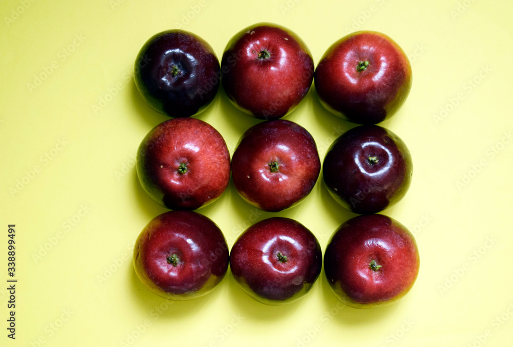 Nine fresh red apples on a yellow background. Nine fresh red apples on a yellow background.
