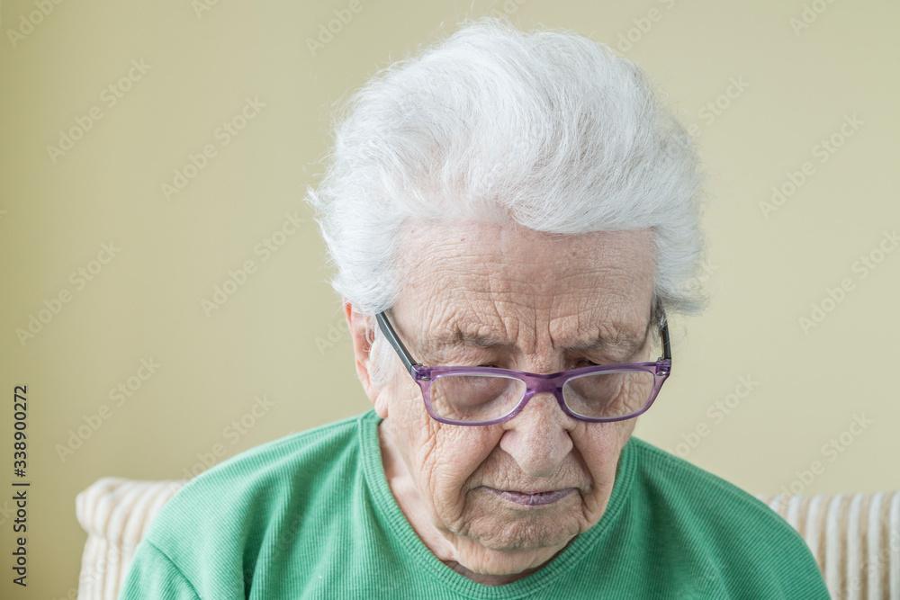 closeup face of old woman wearing eye glasses closeup face of old woman wearing eye glasses
