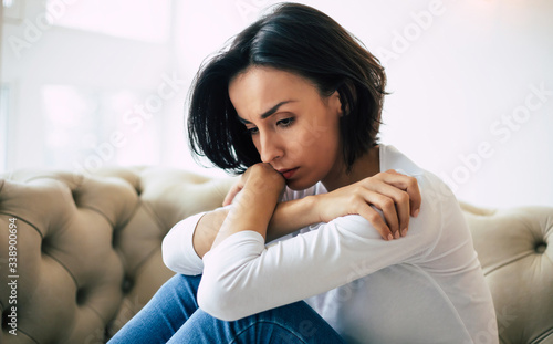 Pain. Close-up photo of a gorgeous sad girl who is sitting at home alone during her depressive episode.