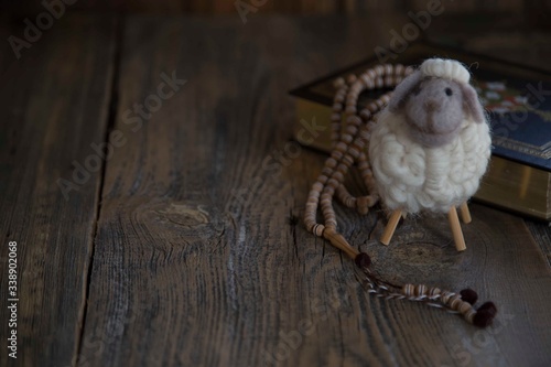 Fototapeta Naklejka Na Ścianę i Meble -  .toy lamb on wooden background..sacrifice feast concept