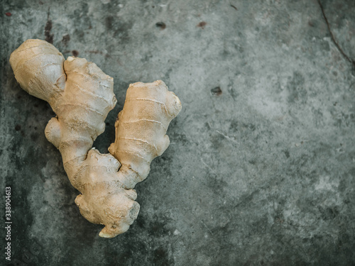 Whole Ginger root on dark grey background, top view.