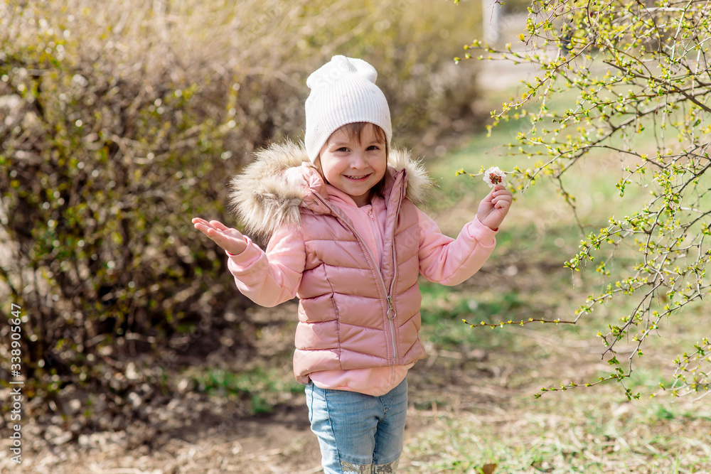Little girl walks in nature in the spring park Little girl walks in nature in the spring park