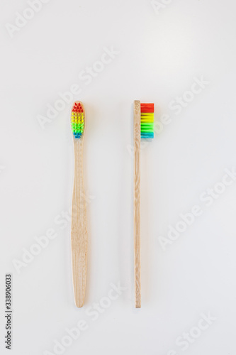 View of bamboo toothbrush front and side. Vertical orientation. Dental zero waste and no plastic concept. Copy space  top view. Natural organic white brush. Isolated on white background.