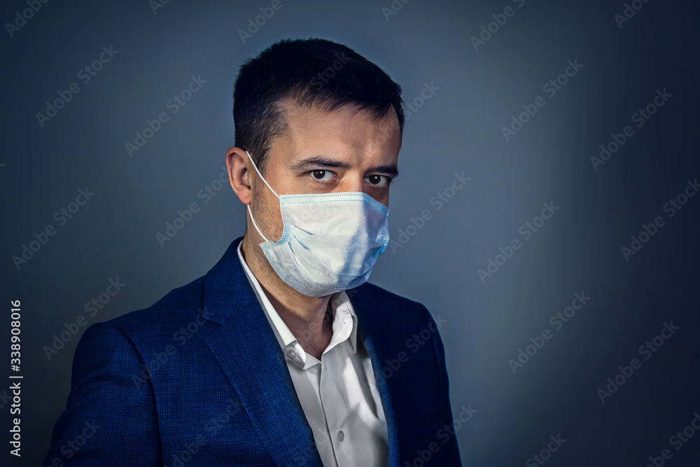 A businessman with an anxious look in a medical mask. Risk of developing a coronavirus infection A businessman with an anxious look in a medical mask. Risk of developing a coronavirus infection