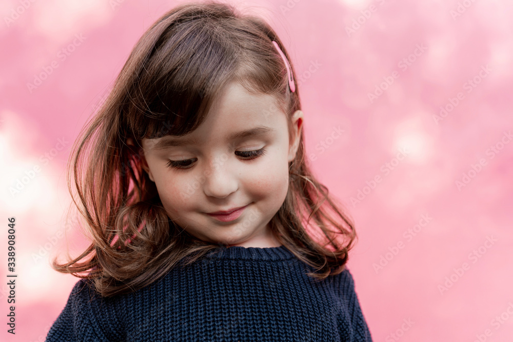 Portrait of smiling little girl in front of pink background Portrait of smiling little girl in front of pink background