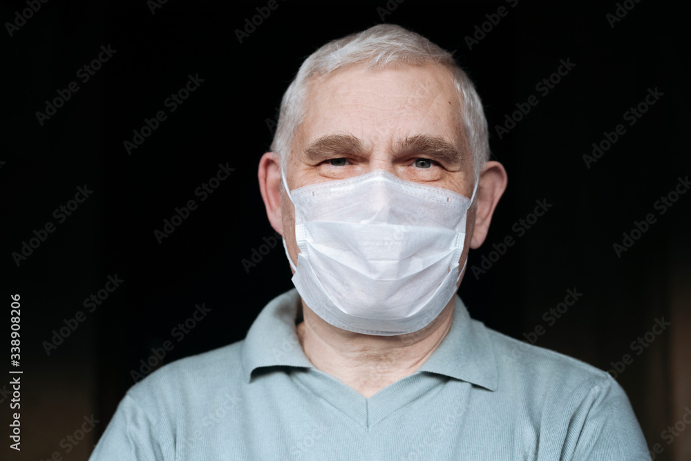 Portrait of senior man wearing a mask at home Portrait of senior man wearing a mask at home