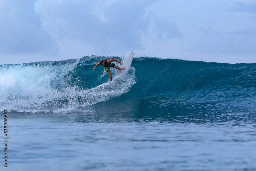 Surfer during rain time, Sumbawa, Indonesia Surfer during rain time, Sumbawa, Indonesia