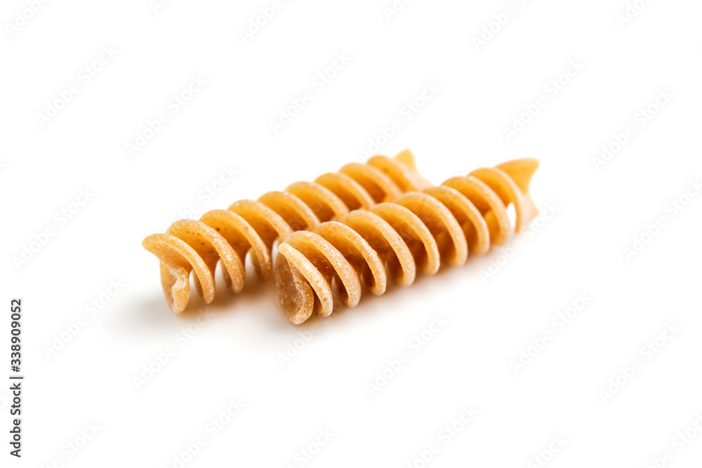 Two pieces of whole grain fusilli pasta on white background Two pieces of whole grain fusilli pasta on white background