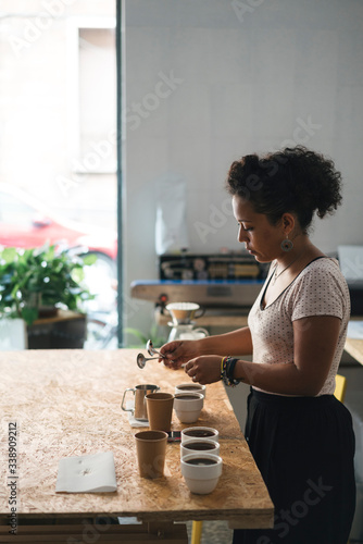 Woman working in a coffee roastery preparing coffee photo