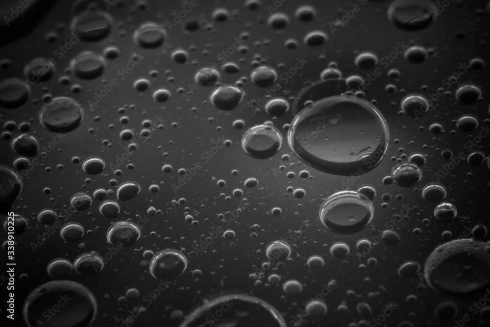 Macro shots cooking oil mixed with water on the glass surface Macro shots cooking oil mixed with water on the glass surface