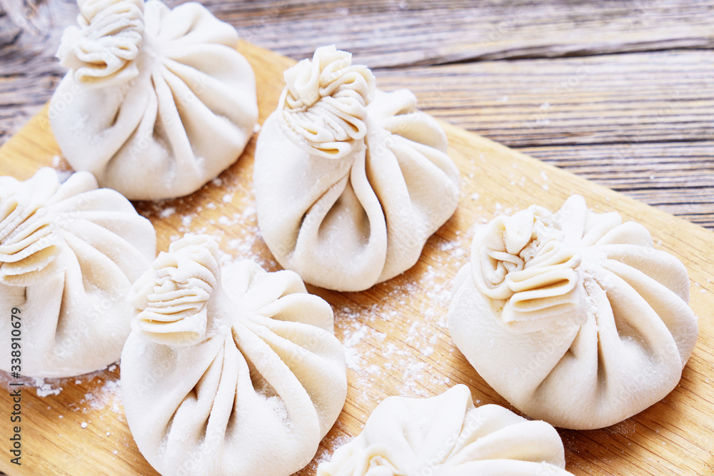 Georgian dumpling or Khinkali. Georgian homemade khinkali on cutting board. Top view, copy space