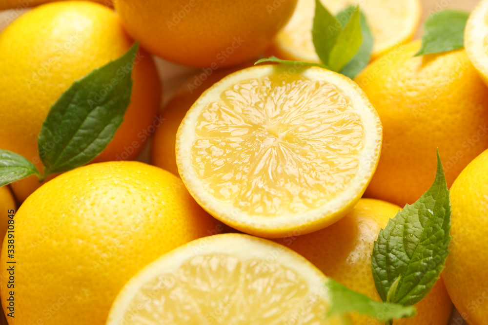 Lemons with leaves on whole background, close up. Ripe fruit
