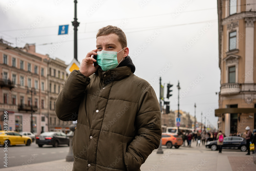 Young man with face mask, commuting in the city, St. Petersburg, Russia Young man with face mask, commuting in the city, St. Petersburg, Russia