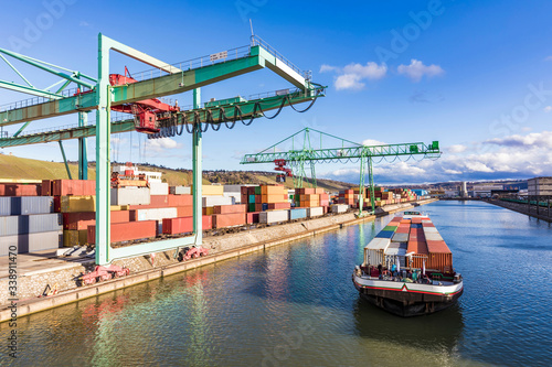 Germany, Baden-Wurttemberg, Stuttgart, Container ship at commercial dock on bank of Neckar river