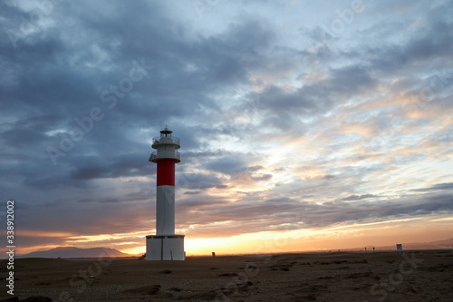 Lighthouse Fangar, in Tarragona, Spain, at sunset