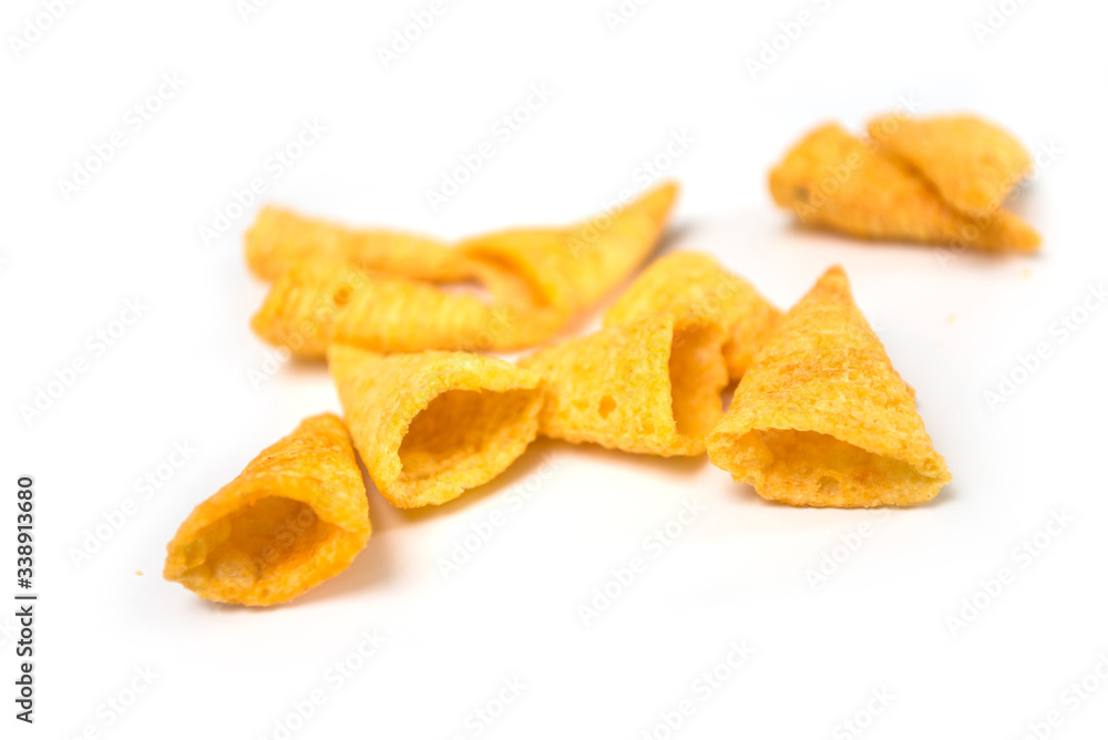 Closeup of bugles salted appetizers pile on white background