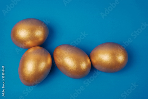 Golden eggs on a blue surface