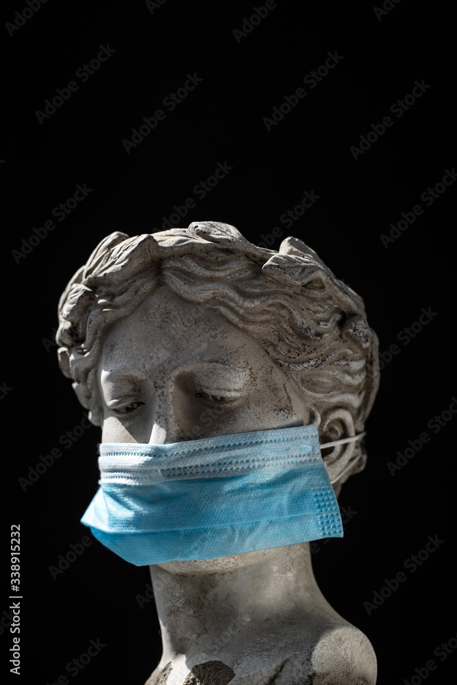 antique statue head in a protective mask