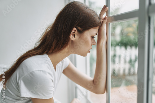 Free Download portrait of a young woman looking at the window - GFXLoad