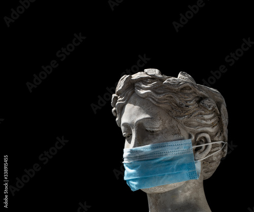 head of a female Italian statue in a protective mask with a sad look