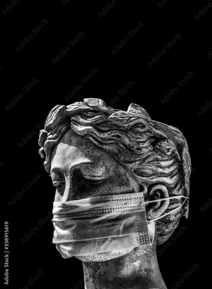 Italian statue in a protective mask with a sad look