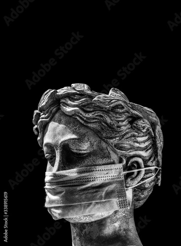 Italian statue in a protective mask with a sad look
