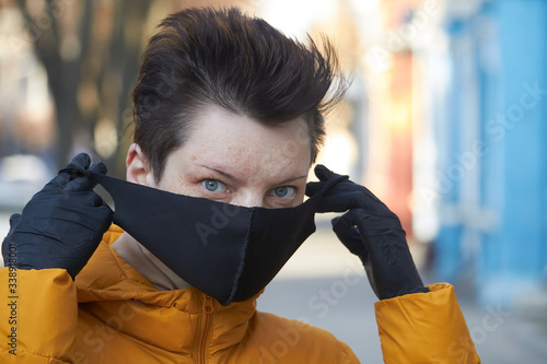 Middle aged european woman in protective black mask, woman wearing mask during coronavirus COVID-19 Epidemic. Sick woman wearing protection during pandemic. photo