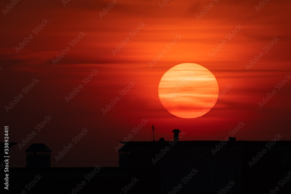 Scenery sun disk over dark building silhouette. Bloody sunrise Scenery sun disk over dark building silhouette. Bloody sunrise