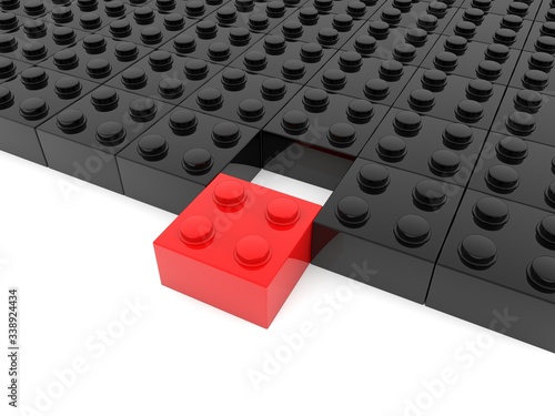 Red toy brick in the foreground for black toy bricks