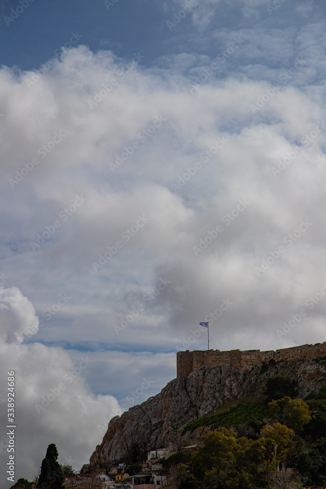 Greek flag on the edge of acropolis hill